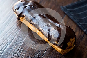 Chocolate Eclairs on Wooden Surface.