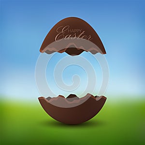 Chocolate egg 3D Happy Easter text. Broken brown Easter egg, blurred green grass field, blue sky meadow background