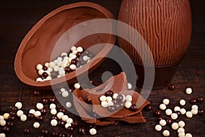 Chocolate egg for Easter on wooden background