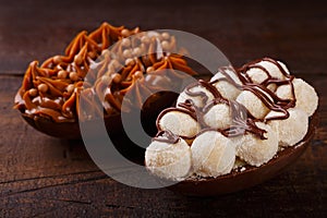 Chocolate egg ith filling for Easter on wooden background