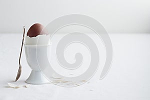 Chocolate egg on white eggstand holder
