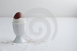 Chocolate egg on white eggstand holder