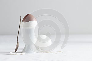 Chocolate egg on white eggstand holder