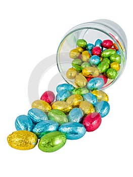 Chocolate eggs spilling out of a jar