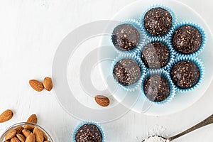 Chocolate energy bites with nuts, cocoa powder, dates and coconut flakes.