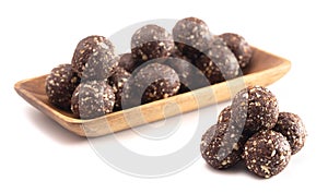 Chocolate Energy Protien Balls Made of Raw Organic Nuts and Dates on a White Background