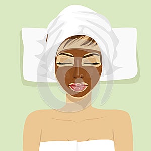 Chocolate facial mask. Chocolate therapy. Young woman with treatment mask on her face at spa salon