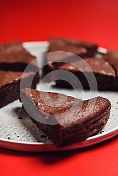 Chocolate Flourless Cake on red background. Soft chocolate gÃ¢teau