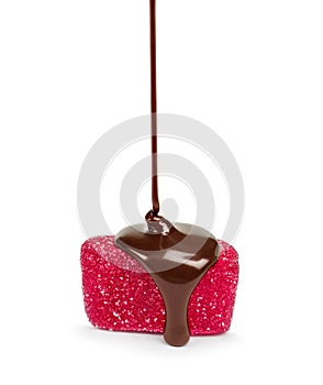 Chocolate flows on a pink jelly candies