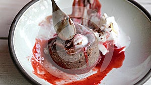 chocolate Fondan with jam and ice-cream on a plate