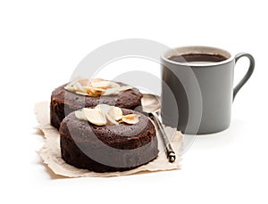 Chocolate fondant with almonds and cup of coffee isolated on wh