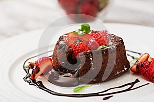 Chocolate fondant (cupcake) with strawberries