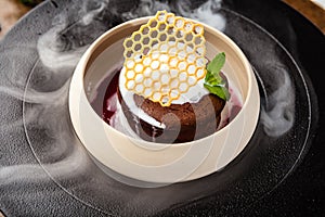 Chocolate fondant. Dark chocolate, raspberry sauce, vanilla ice cream dessert. Delicious healthy traditional food