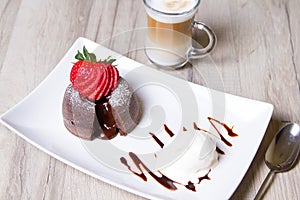 Chocolate fondant lava cake with strawberries and ice cream