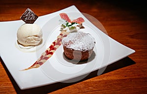 Chocolate fondant lava cake with vanilla ice cream, creamy sauce