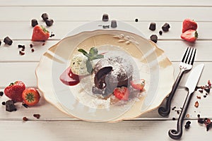 Chocolate fondant with vanilla ice cream and strawberry