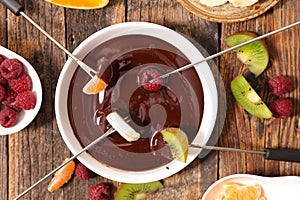 Chocolate fondue with fruits photo
