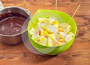 Chocolate fondue on an old rustic wooden table