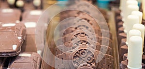 Chocolate formed in wrist watch. Selective focus