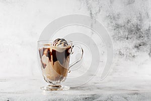 Chocolate frappe with whipped cream, chocolate syrup and ice cream on bright marble background. Overhead view, copy space.