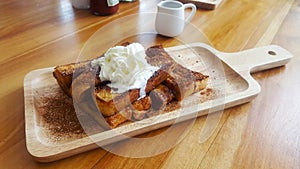 Chocolate french toast with cinnamon sugar on wooden plate