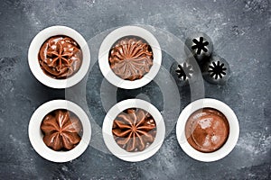 Chocolate frosting swirls and various metal confectionery nozzle