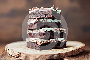 Chocolate fudge with minty cream on a wooden background. Closeup view.