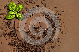 Chocolate Game Controller with Basil on Cocoa Background