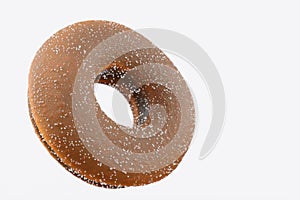 Chocolate glazed donut with sugar on a white background