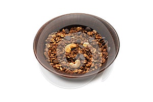 Chocolate granola cereal with nuts in a bowl background