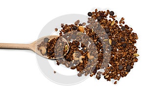 Chocolate granola cereal with nuts in a wooden spoon