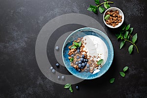 Chocolate granola with white plain yogurt and fresh blueberry in a bowl, healthy food for breakfast