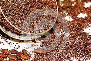 Chocolate granules in glass containers. Ingredient for making confectionery. Close-up