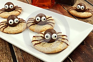 Chocolate Halloween spider cookies on a white plate