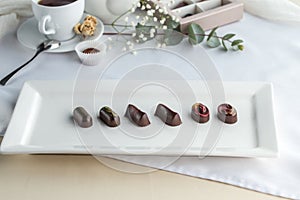 Chocolate handmade candies and cup of tea on the table