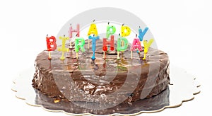 Chocolate happy birthday cake on silver tray towards white