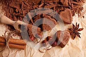 Chocolate heart-shaped candy on a rustic background, chocolate composition