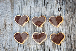 Chocolate heart on wooden background for gift in Valentine`s day love.