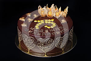 Chocolate homemade cake with golden decor and inscription