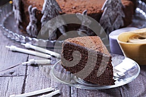 Chocolate honey cake in a Christmas decoration on a wooden background.
