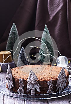 Chocolate honey cake in a Christmas decoration on a wooden background