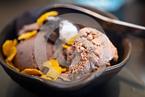 Chocolate ice cream ball topping with corn flake and chocolate biscuits