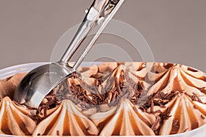 Chocolate ice cream being scooped up