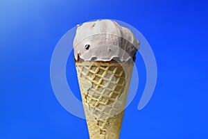 Chocolate ice cream cone on blue background photo