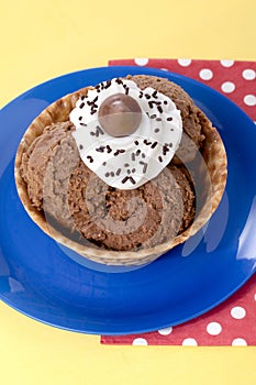 Chocolate ice cream cone on a blue plate