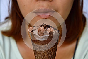 Chocolate ice cream in front of woman stain lip