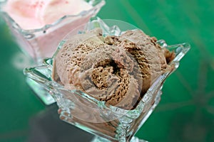 Chocolate ice cream in a glass vase.