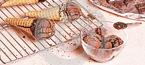 Chocolate ice cream on a metal rack with scoop from stainless stee, banner