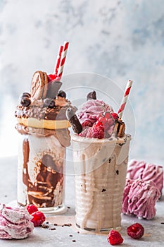 Chocolate indulgent frosting exreme milkshake with donut  and sweets. Crazy freakshake food trend. Copy space