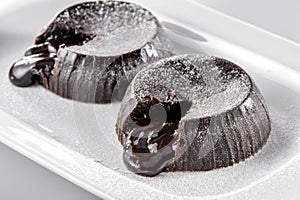 Chocolate lava brownie cakes with powdered sugar close-up